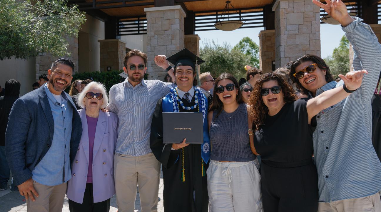 Student and family celebrating at graduation