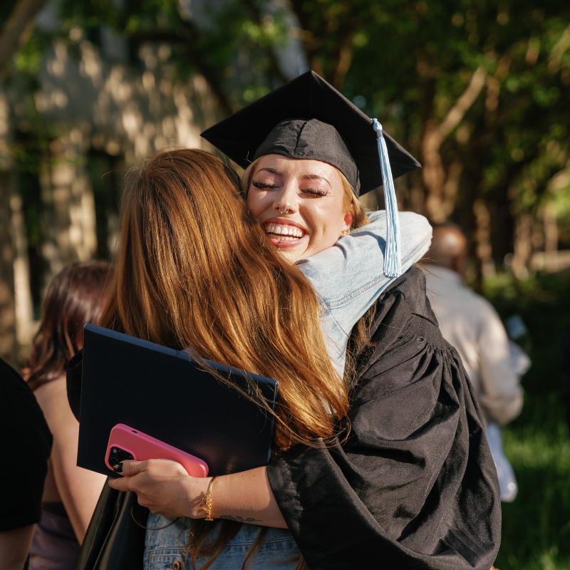 Family hugging on graduation