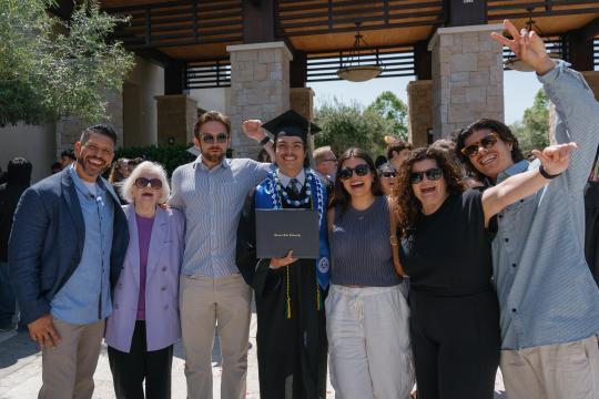 Student and family celebrating at graduation